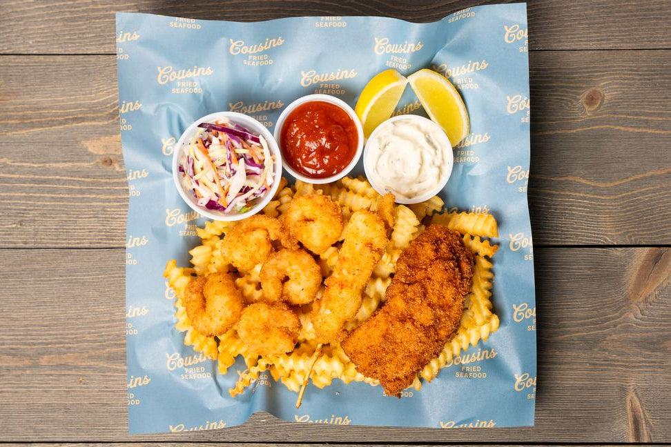 Plated seafood dish with sides on a wooden surface